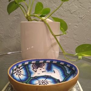 This is a wooden bowl with beads